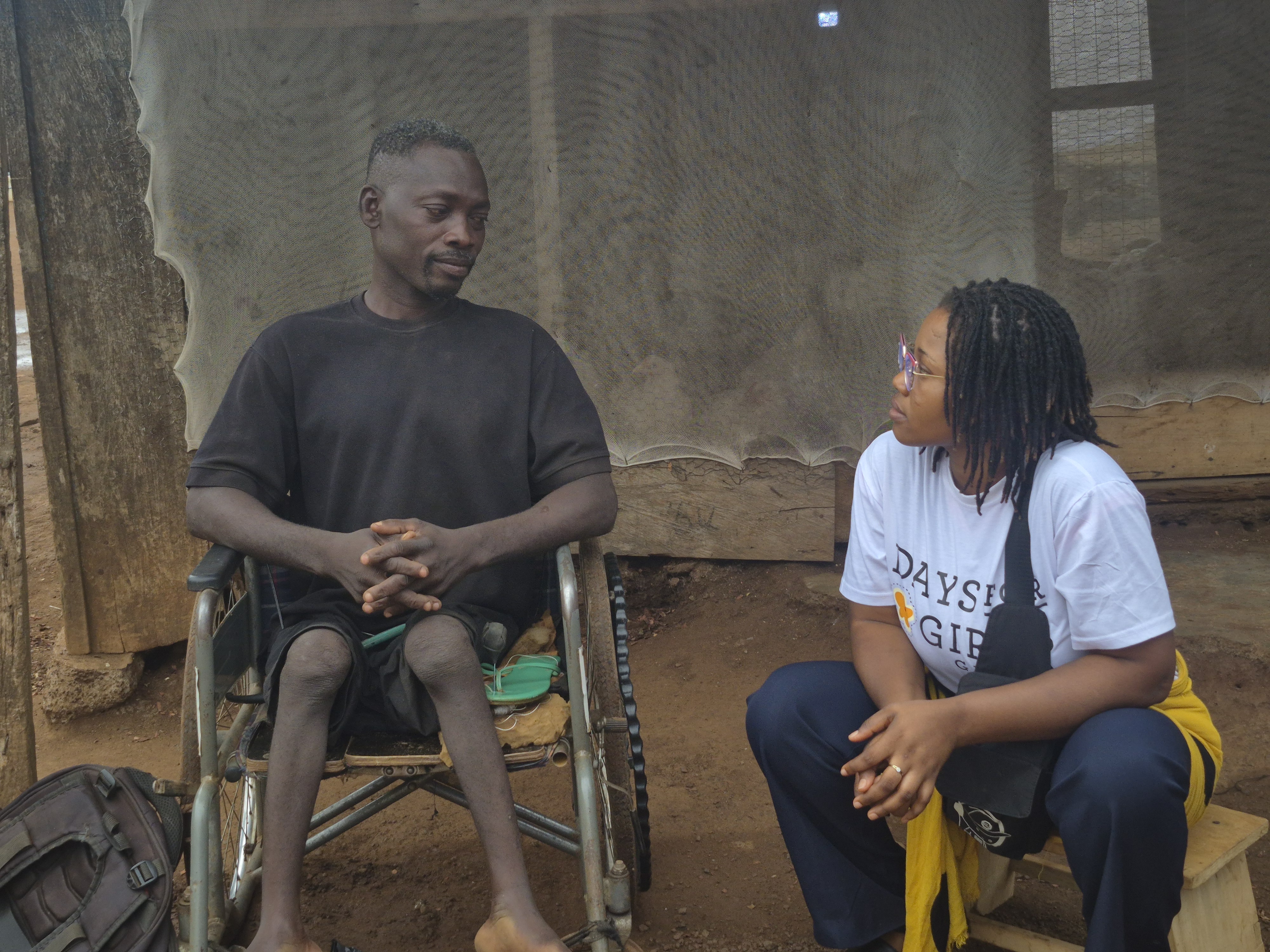 A Passion for Humanity Ghana counsellor in conversation with a community member during a disability-inclusion outreach