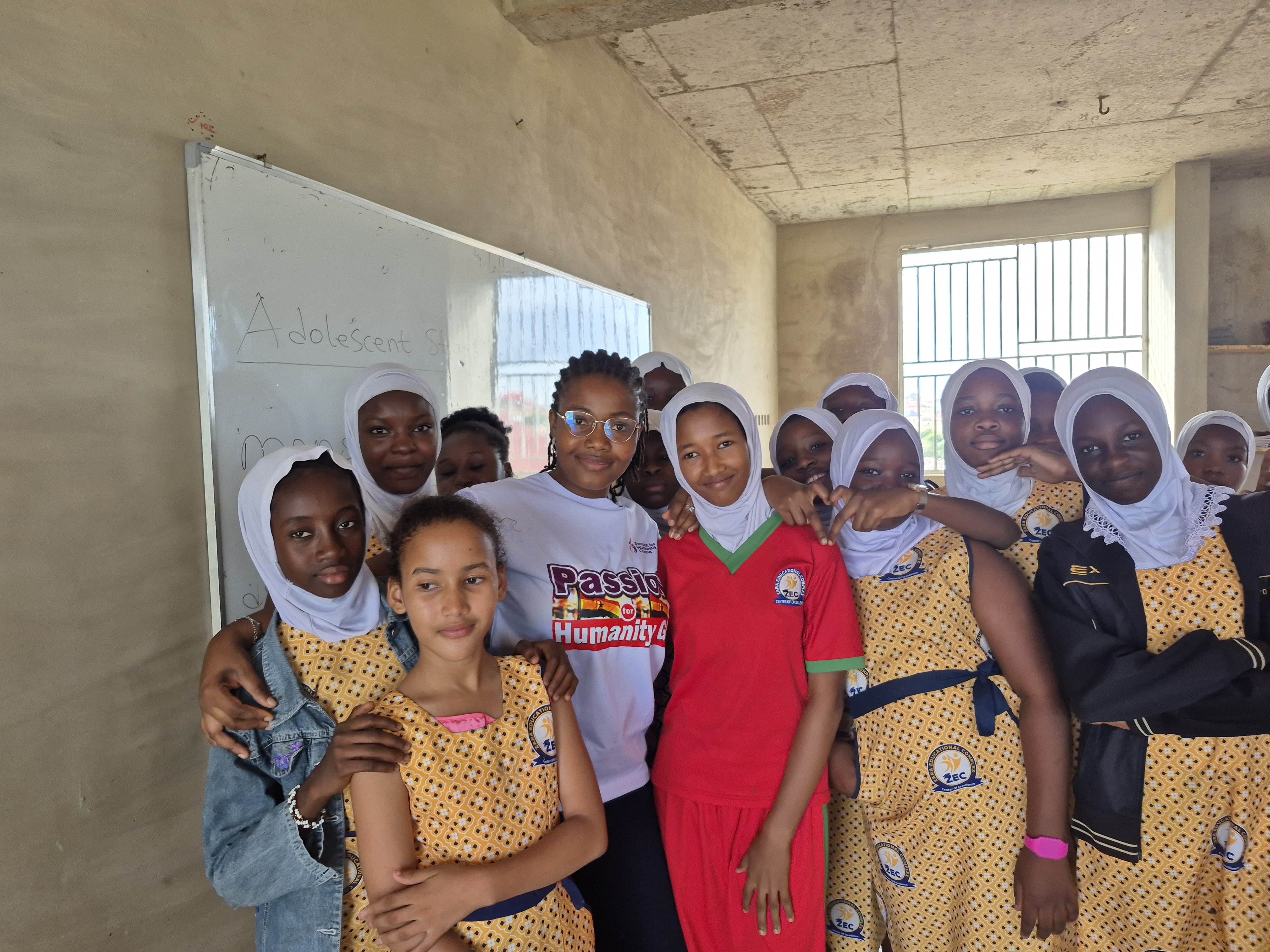 School girls and a volunteer during an adolescent sensitization session
