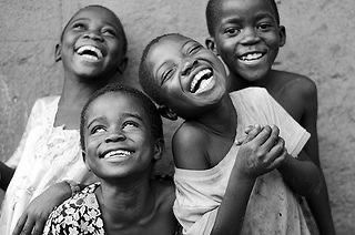 Joyful children laughing together in a black and white portrait